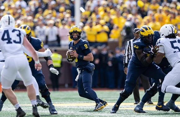 Zak Zinter (65), J.J. McCarthy (9), and Olusegun Oluwatimi (55)