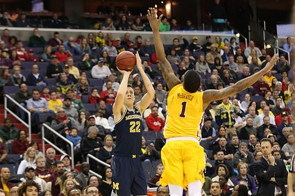Duncan Robinson (22) and Minnesota Head Coach Richard Pitino
