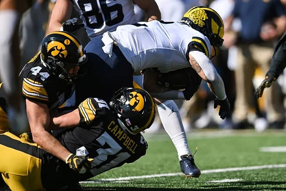 Blake Corum (2) and Luke Schoonmaker (86)