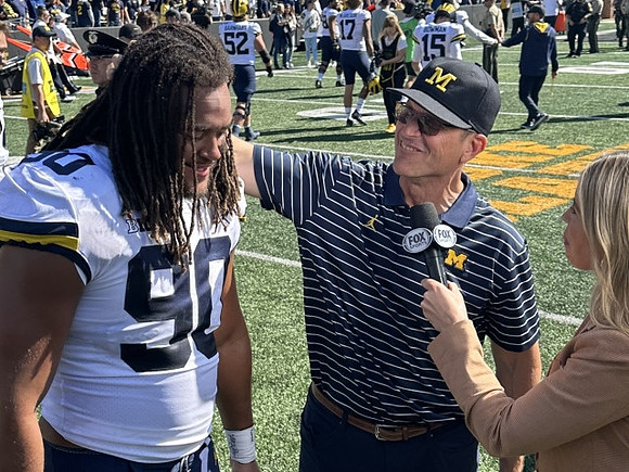Mike Morris (90) and Jim Harbaugh