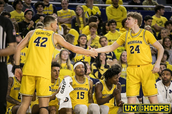 Will Tschetter (42), Sam Walters (24), and Michigan Team