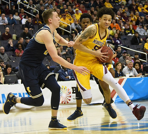 Duncan Robinson (22) and Derrick Walton Jr. (10)