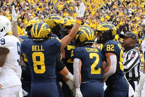 Ronnie Bell (8), Blake Corum (2), and Max Bredeson (82)