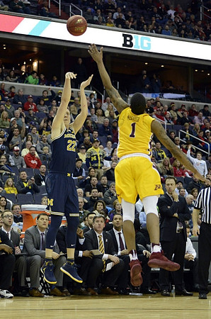 Duncan Robinson (22) and Minnesota Head Coach Richard Pitino