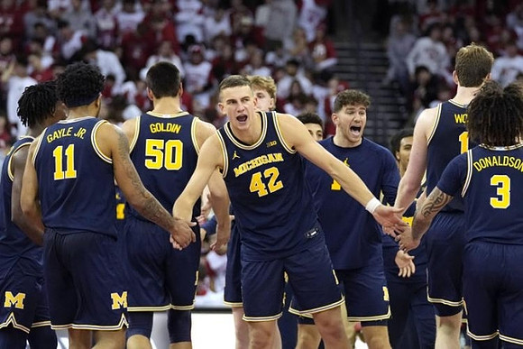 Will Tschetter (42) and Michigan Team