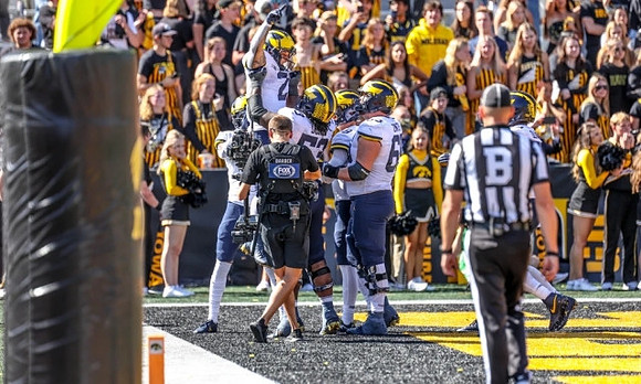 Blake Corum (2), Trente Jones (53), and Zak Zinter (65)