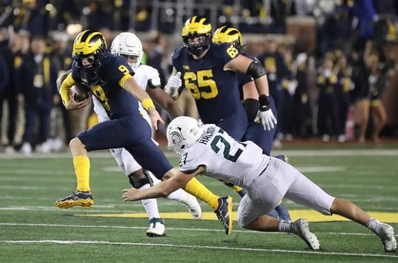 J.J. McCarthy (9) and Zak Zinter (65)