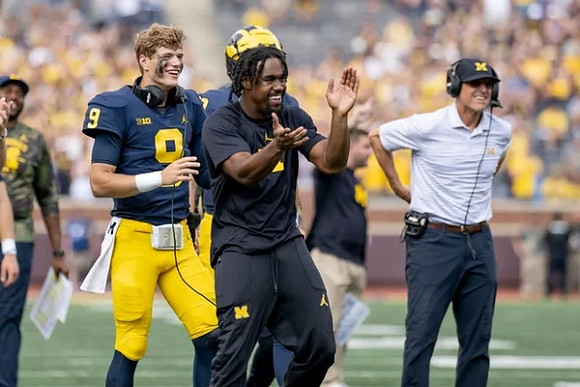 J.J. McCarthy (9), Donovan Edwards (7), and Jim Harbaugh