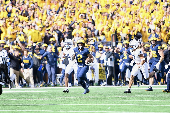 Blake Corum (2), J.J. McCarthy (9), and Luke Schoonmaker (86)