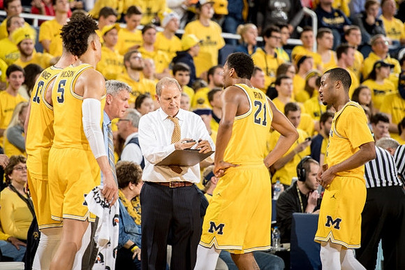 Moritz Wagner (13), D.J. Wilson (5), Jeff Meyer, John Beilein, Zak Irvin (21), and Muhammad-Ali Abdur-Rahkman (12)