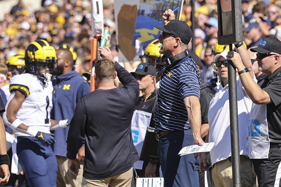 Andrel Anthony (1) and Jim Harbaugh