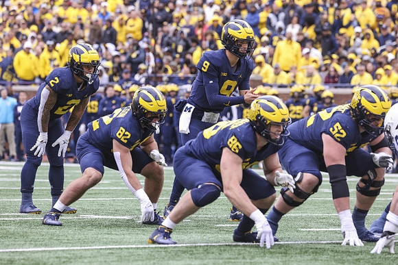 Blake Corum (2), Max Bredeson (82), Luke Schoonmaker (86), J.J. McCarthy (9), and Karsen Barnhart (52)