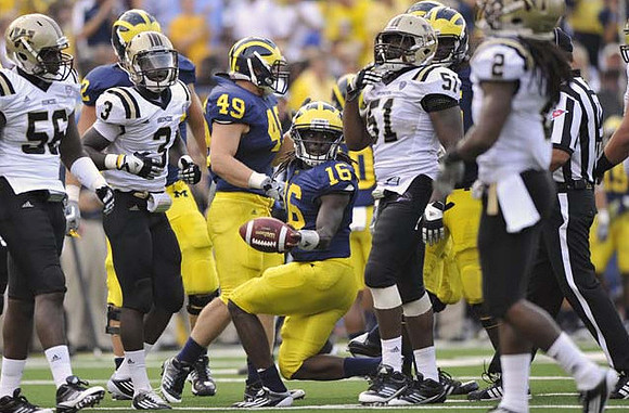 John McColgan (49) and Denard Robinson (16)