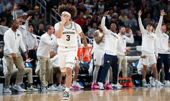 Tre Donaldson (3) and Michigan Team