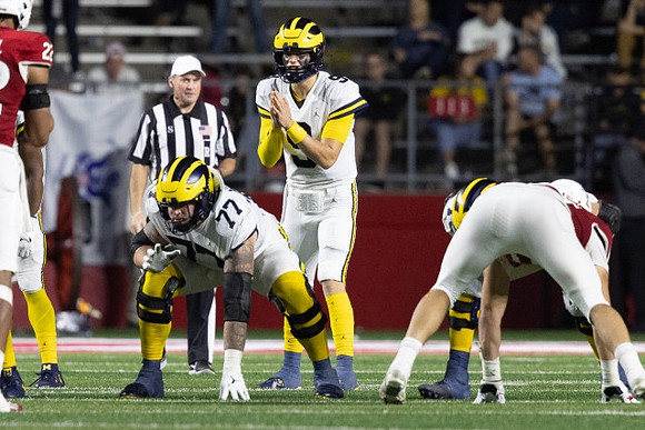 Trevor Keegan (77) and J.J. McCarthy (9)