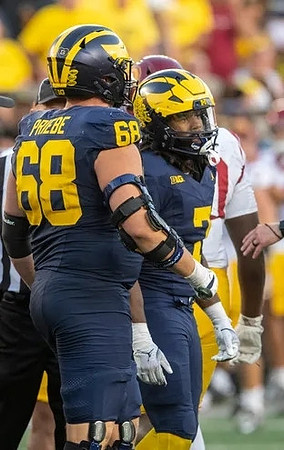 Josh Priebe (68) and Donovan Edwards (7)