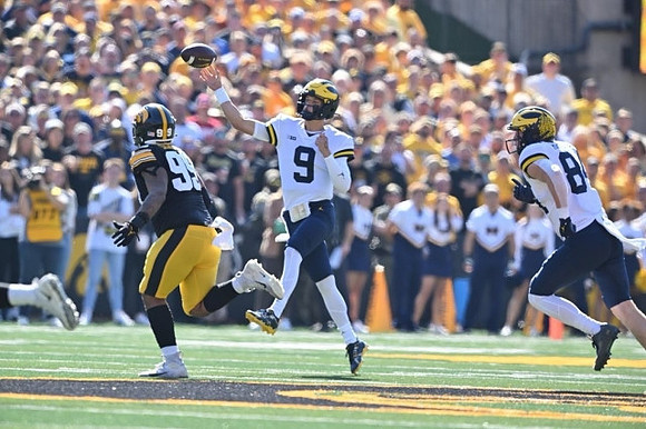 J.J. McCarthy (9) and Joel Honigford (84)
