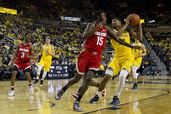 Moritz Wagner (13), Zak Irvin (21), and D.J. Wilson (5)