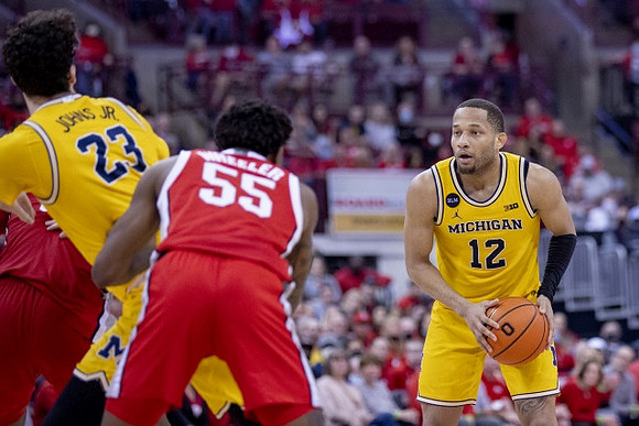 DeVante' Jones (12) and Brandon Johns Jr. (23)