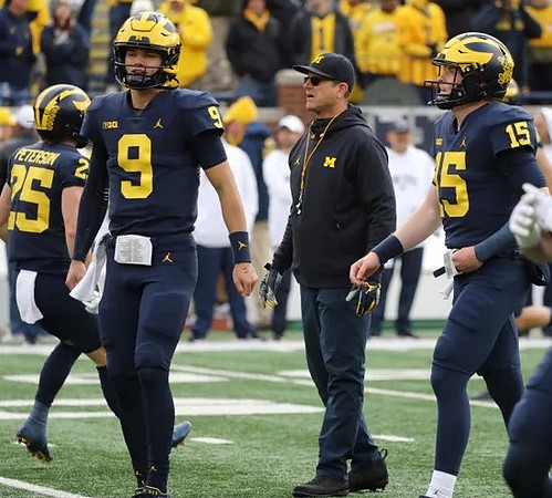 Zach Peterson (25), J.J. McCarthy (9), Jim Harbaugh, and Alan Bowman (15)