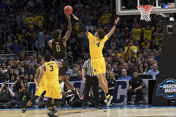 Charles Matthews (1), Zavier Simpson (3), and Isaiah Livers (4)