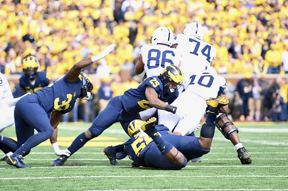 Jaylen Harrell (32), Mazi Smith (58), and Junior Colson (25)